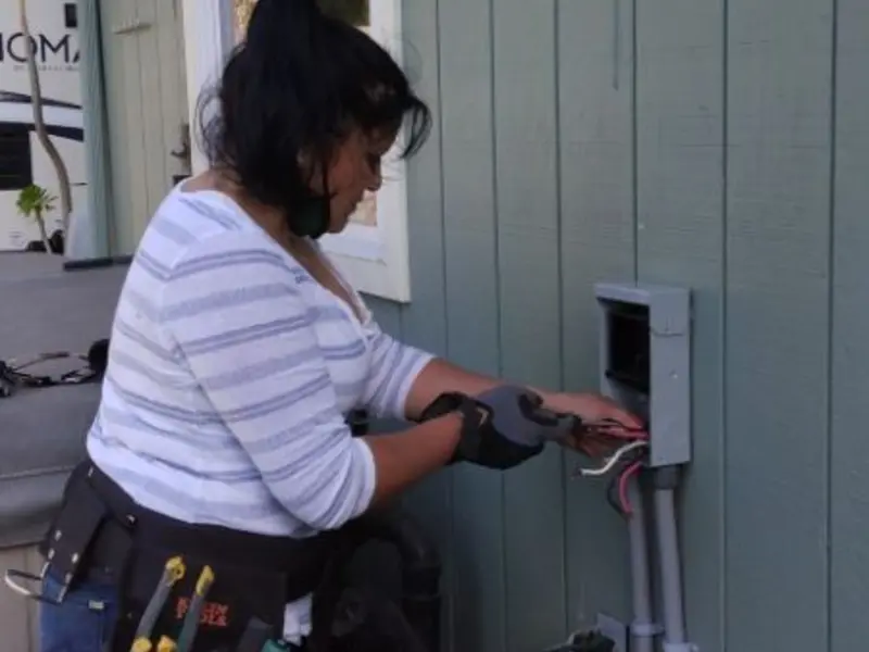 Licensed electrician wiring an exterior subpanel in Flagstaff